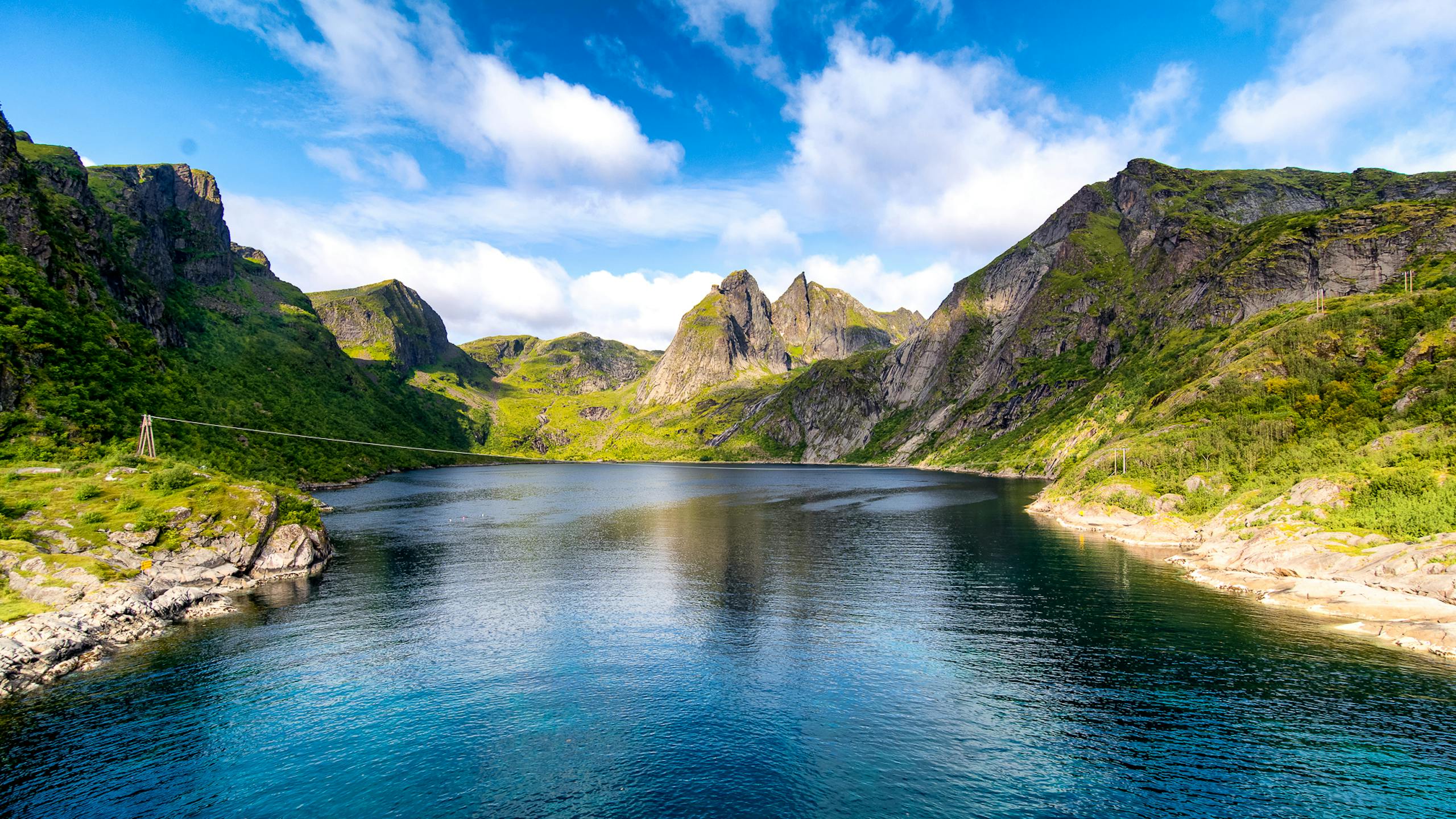 Beautiful landscape of a fjord surrounded by mountains and clear water in Moskenes, Norway.