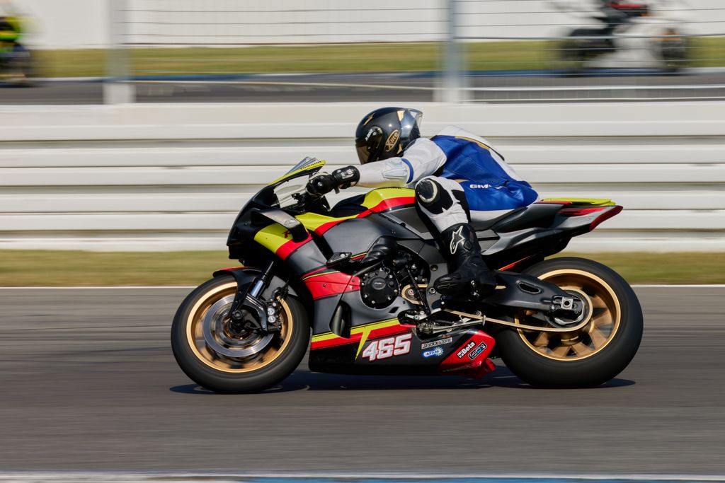 Dynamic shot of a superbike racer speeding on Hockenheim circuit in Germany.