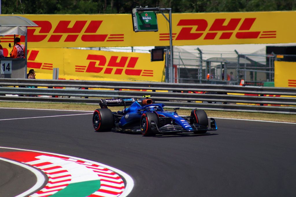 High-speed Formula 1 car on the track during a sunny day at Hungaroring, Hungary.