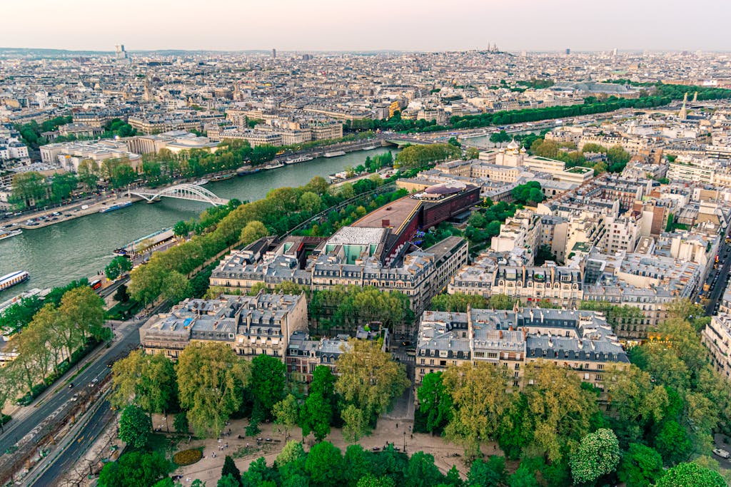 Stunning aerial view of Paris showcasing the Seine River and iconic architecture under a clear sky.